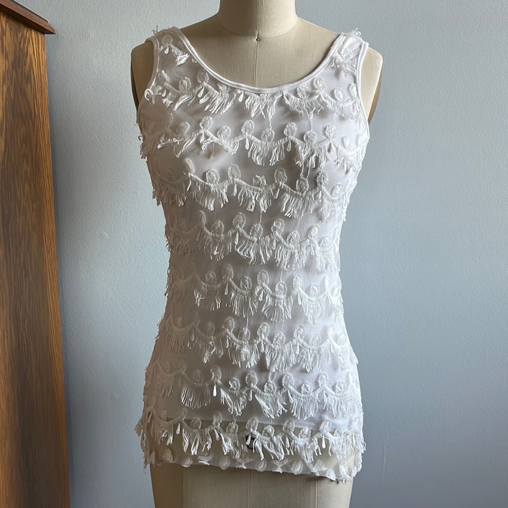 Solution white tank top with fringed front.